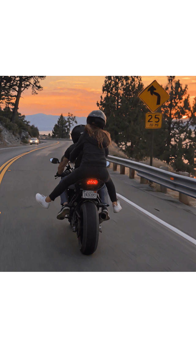 Passenger holding onto the rider's jacket without a dedicated grip handle