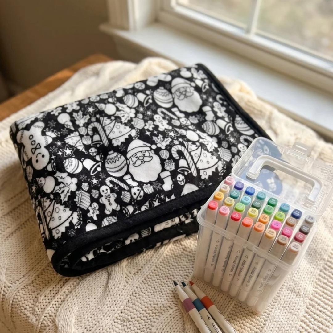 Coloring blanket and markers on a bed