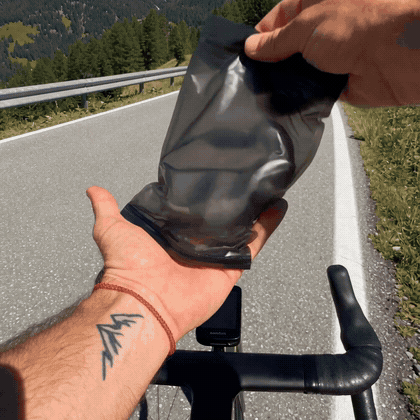 Holding Wanderlens camera headphones in one hand while riding